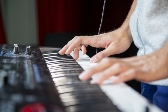 Hands play a keyboard instrument.